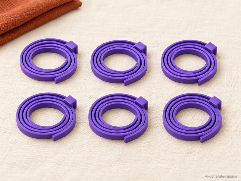 6 purple Pheromone Collars, coiled, on a linen cloth